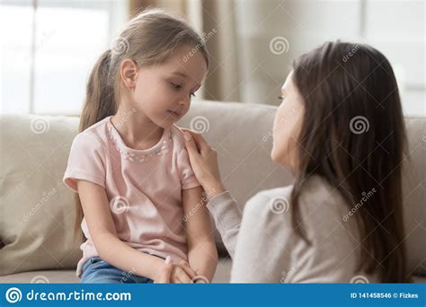 Loving Mom Talking To Upset Little Child Girl Giving Support Stock