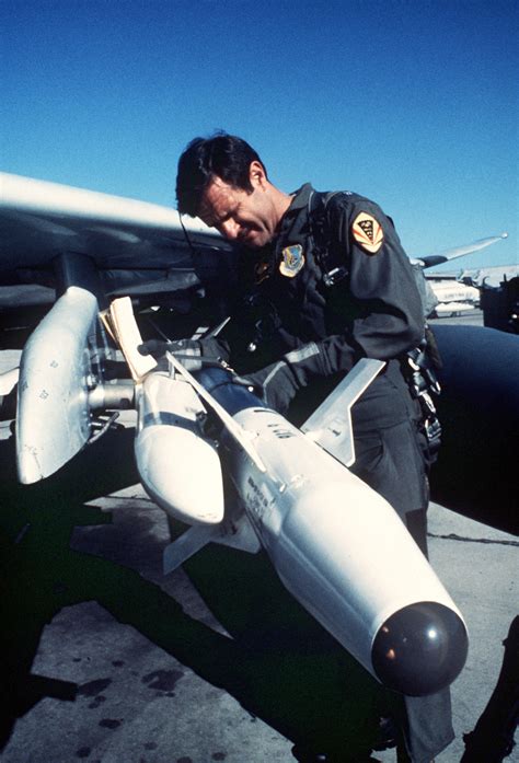 A Pilot Checks An Aim 9np Sidewinder Missile Aboard An F 4 Phantom Ii