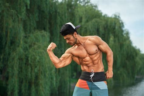 Bodybuilder With Naked Torso Showing Muscles Outdoors Stock Photo Image Of Biceps Posing