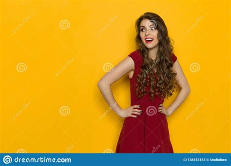 Beautiful Woman In Red Dress Is Looking Away And Talking Stock Image