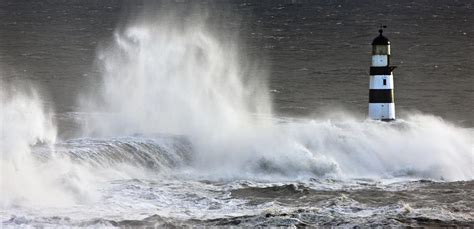 Waves Crashing On A Lighthouse Photograph By John Short Pixels