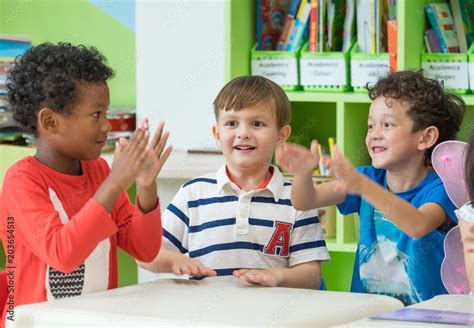 Group Of Diversity Kids Boy Sit On Table And Playing Together In