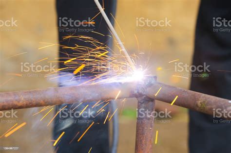 Welders Working And Jointing Iron Pipe At The Factory Stock Photo