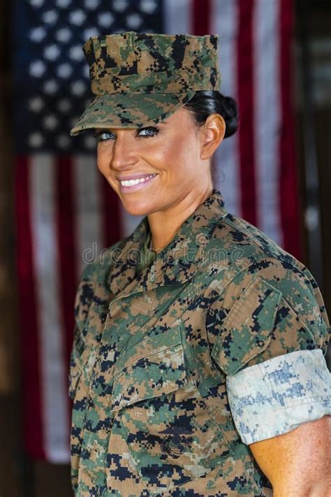 A United States Female Marine Posing In A Military Uniform Stock Photo