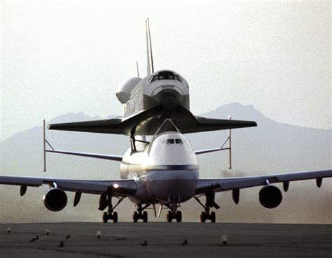 The Space Shuttle Discovery Piggy Backing On A Modified Boeing 747