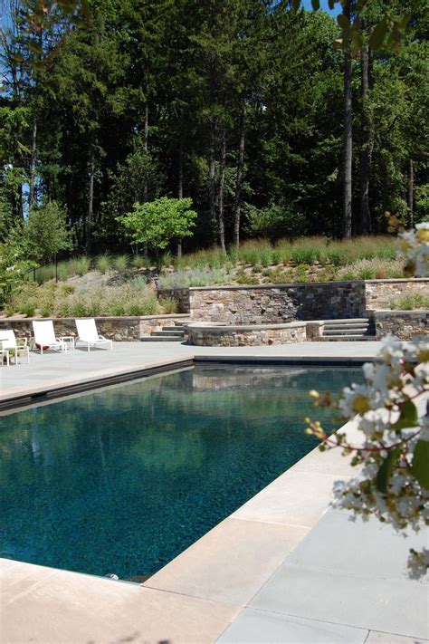 Concrete Swimming Pool Patio With Elevated Hot Tub And Planted Hillside
