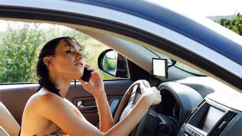 Premium Photo Woman Driver With Her Hand On The Steering Wheel Using A Mobile Phone And Losing