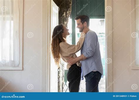 Affectionate Wife Embracing Smiling Husband Meeting At House Door Stock Image Image Of Hold