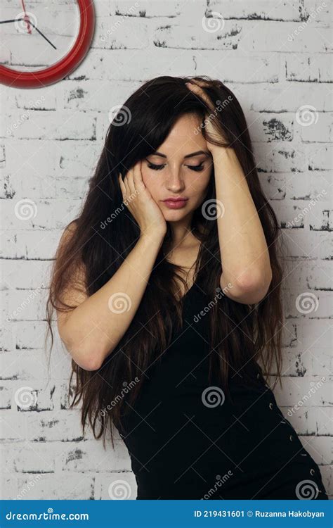 A Woman In A Black Dress Against A White Wall Stock Image Image Of