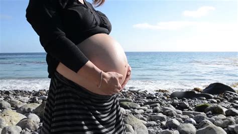 Pregnant Woman With Husband Rubbing Her Belly On The Beach Sepiafilm Burn Stock Footage Video