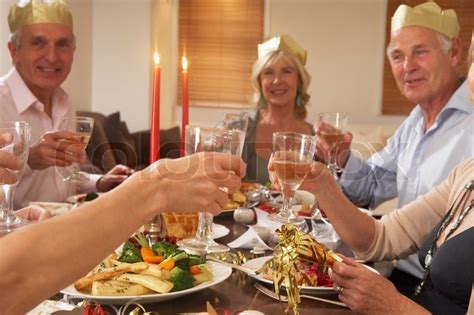 What do brits eat during christmas dinner? Elderly couples enjoying their Christmas dinner | Stock Photo | Colourbox