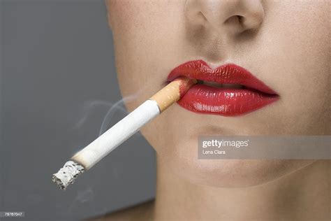 A Woman Wearing Red Lipstick And Smoking A Cigarette Photo Getty Images