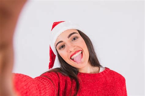 Free Photo Woman In Christmas Hat Showing Tongue Out