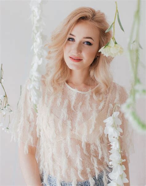 Portrait Of Beautiful Young Blonde Woman With Flowers Stock Photo