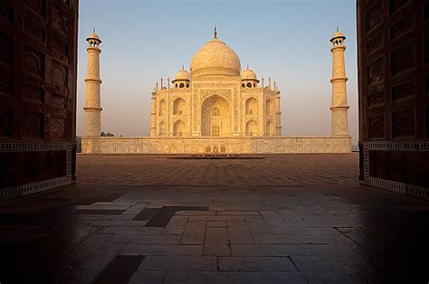 Glossy Ground The Taj Mahal At Sunrise Is Seen Through The Doors Of