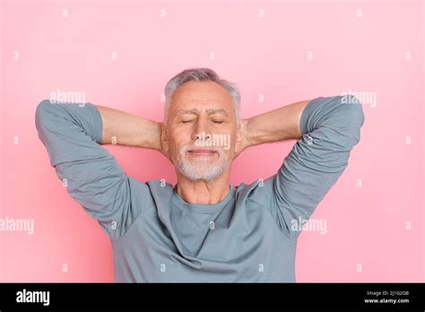 Photo Of Funny Dreamy Retired Man Wear Grey Shirt Arms Behind Head