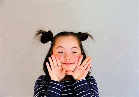 Premium Photo Cute Smiling Down Syndrome Girl On The Grey Background