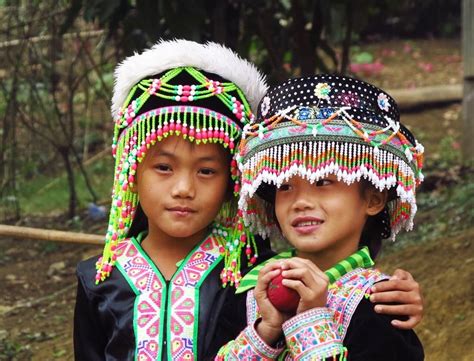 During the Hmong New Year celebration, boys and girls play 'pov pob'. They form pairs and toss a ...