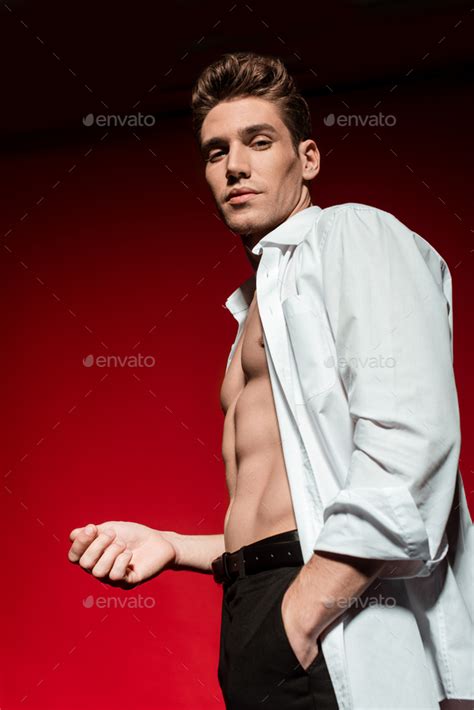 Low Angle View Of Sexy Young Elegant Man In Unbuttoned Shirt With