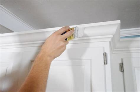 Measure along cabinet sides and around walls to get the length of each piece. How To Add Crown Molding To The Top Of Your Cabinets ...