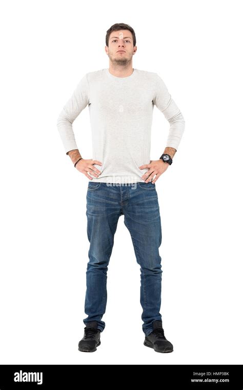 Front View Of Confident Young Casual Man With Arms On Hips Full Body