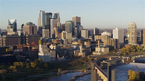 5 7k stock footage aerial video passing by the city skyline seen from the river at sunrise