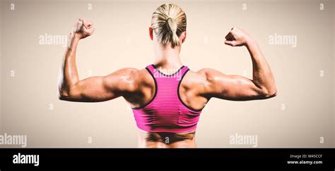 Composite Image Of Muscular Woman Flexing Her Arms Stock Photo Alamy