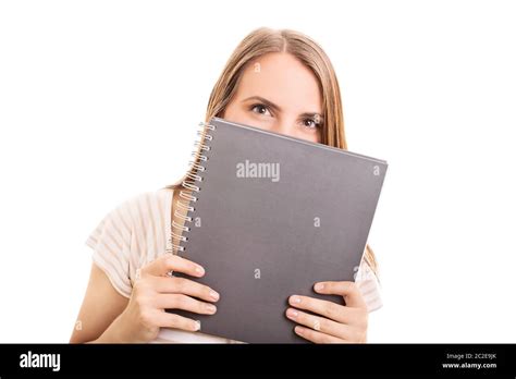 Beautiful Girl Hiding Her Smile Behind A Notebook Isolated On White Background Girl With A