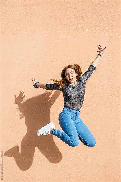 Happy Girl Jumping In Front Of A Wall Outside Del Colaborador De