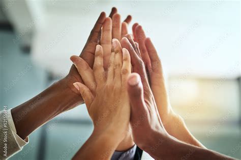 Hands Huddle And High Five While A Group Of Diverse Businesspeople