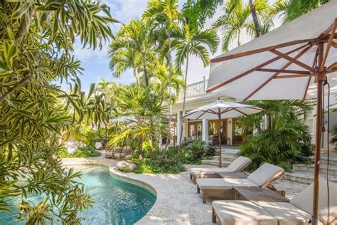 Tall Palm Trees Surround This Lush Tropical Backyard Garden A Swimming