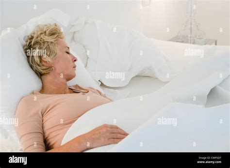 Mature Woman Sleeping In Bed Stock Photo Alamy
