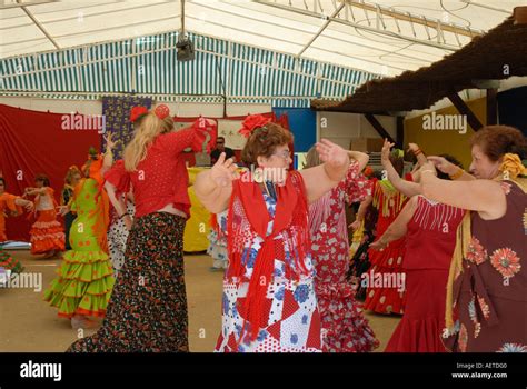 middle aged spanish women dance flamenco in traditional dress on ladies day at vejer spring