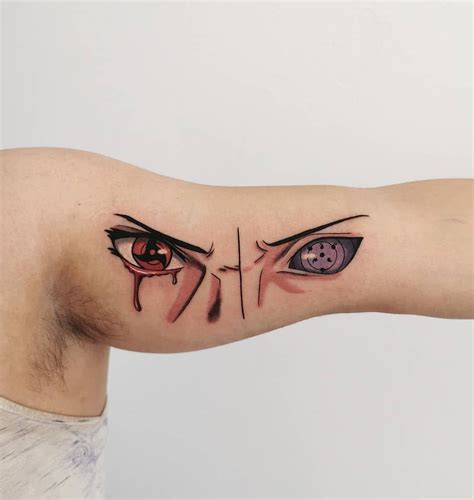 A Mans Arm With An Evil Face And Eyeball Tattoo On The Left Side Of