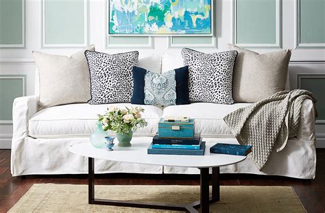 Arrange the rest of the pillows in descending order of size. Arranging Sofa Cushions: 9 easy ways to style it! | InteriorFlux