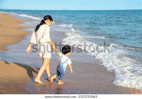 Mother Son Walk On Beach This Stock Photo 1353755063 Shutterstock