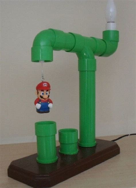 A Nintendo Wii Game Controller And Some Green Pipes