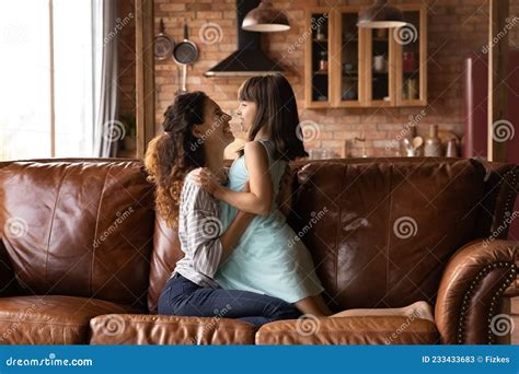 Happy Laughing Mom Cuddling Daughter Girl On Couch At Home Stock Image Image Of Girl Mommy