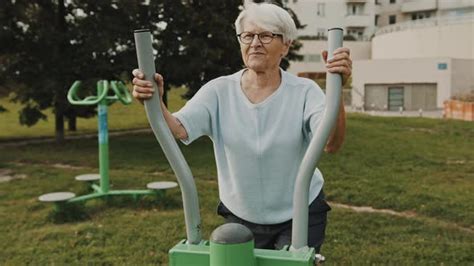 Gray Haired Granny Exercising At Outdoors Gym Playground Equipment Stock Footage