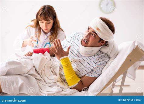 The Young Doctor Examining Injured Patient Stock Photo Image Of