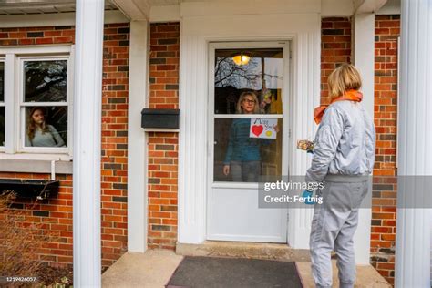 neighbors helping each other a friend delivers a small wrapped t to her friends doorstep high