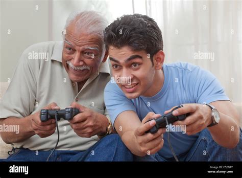 Grandfather And Grandson Playing Video Game Stock Photo Alamy