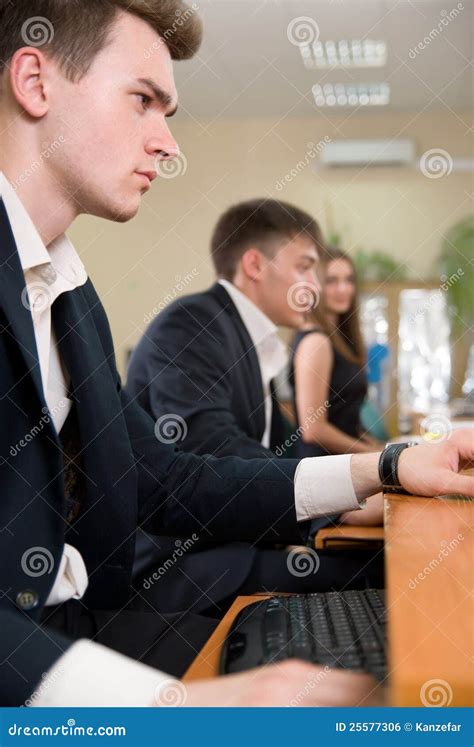 Young Business People Sitting At A Table Stock Photo Image Of