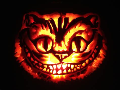 A Pumpkin Carved To Look Like A Cats Face Is Lit Up In The Dark