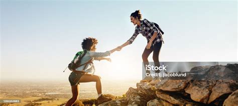 Helping Each Other To The Top Of Mountain Stock Photo Download Image