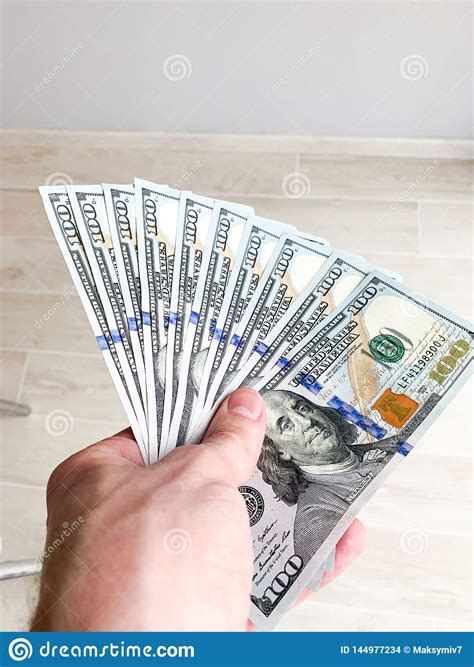 Hand Holding Banknote Bundle Of Us Dollar In Hand Stock Photo Image