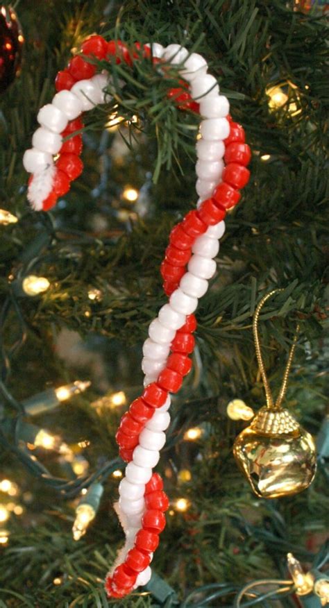 We've always found it much easier for our daughter to string beads onto a pipe cleaner than onto string. Easy Candy Cane Ornament Craft - Fantastic Fun & Learning