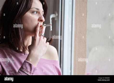 Young Woman Standing Window Smoking Hi Res Stock Photography And Images