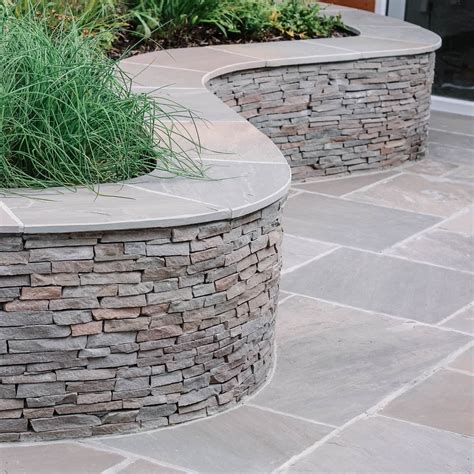 A Curvy Stacked Stone Wall Stone Walls Garden Landscaping Retaining