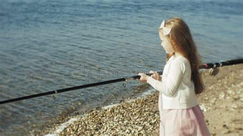 Cute Little Girl Is Playing With A Fishing Rod On A Fishing Boat Near